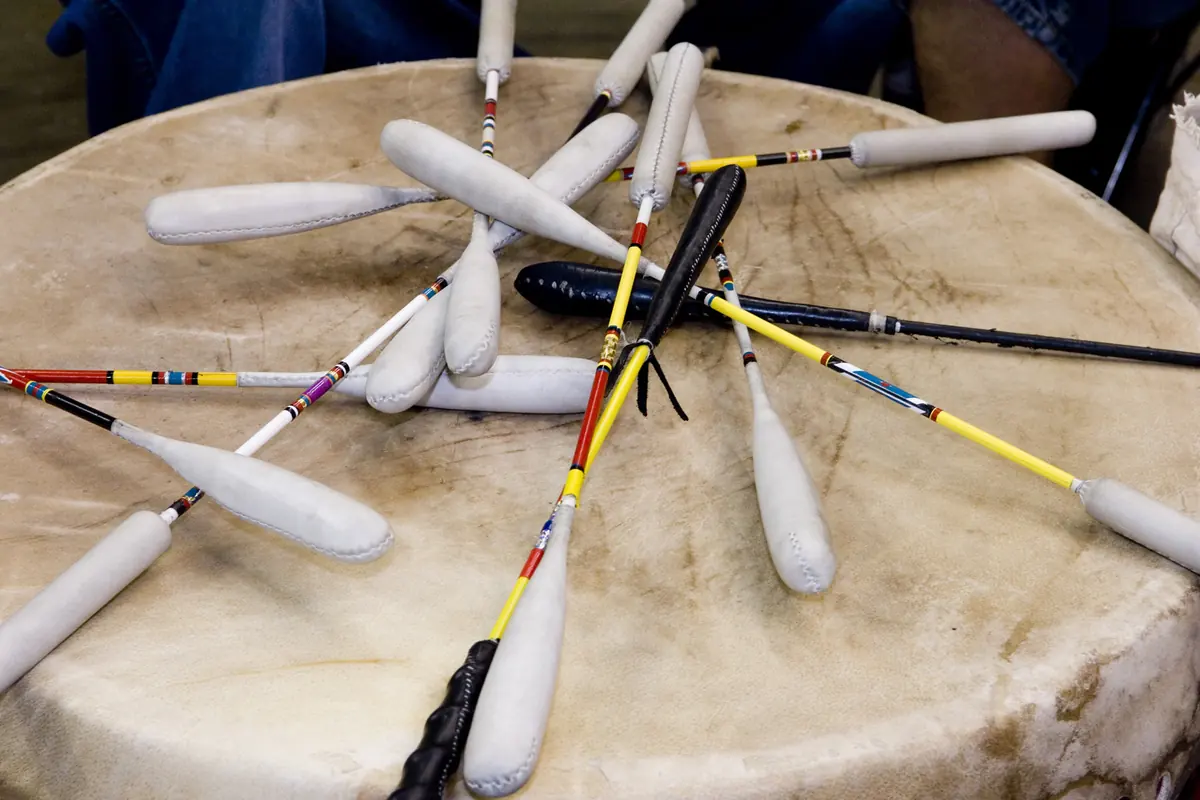 Drumsticks lying on the head of a powwow drum, photographed at a Smithsonian powwow.