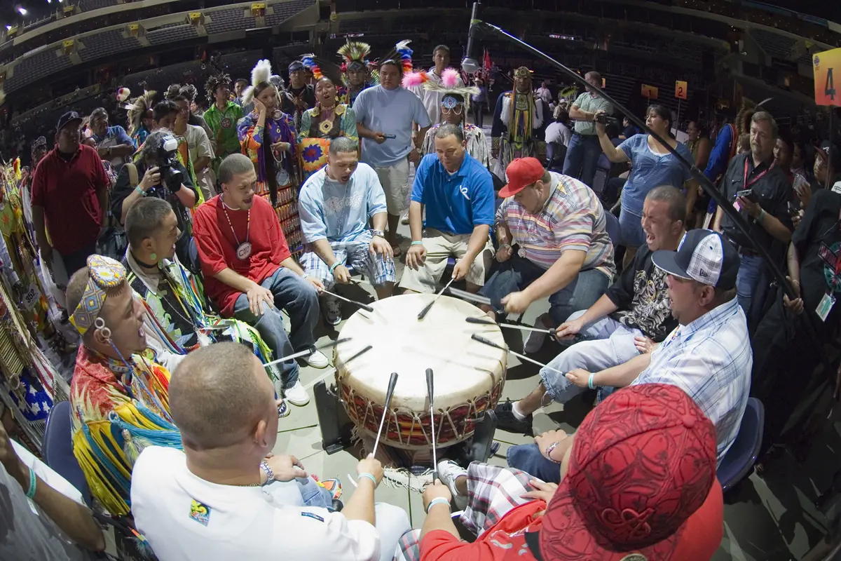 A ring of singers around a powwow drum, photographed at a Smithsonian powwow.